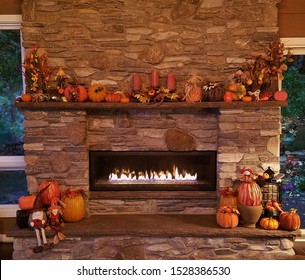 Warm and Cozy Large, Rustic Stone Fireplace with Surrounding Pumpkins and Autumn Decor; Cozy Home, Rustic Decor, Holiday Ideas - Shutterstock ID 1528386530