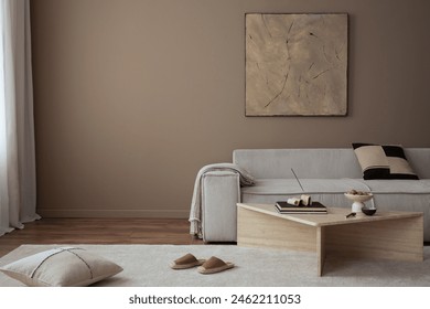 Warm and cozy living room interior with mock up poster frame, painting, beige sofa, travertine coffee table, slippers, bowl with nuts, plaid, pillow and personal accessories. Home decor. Template.