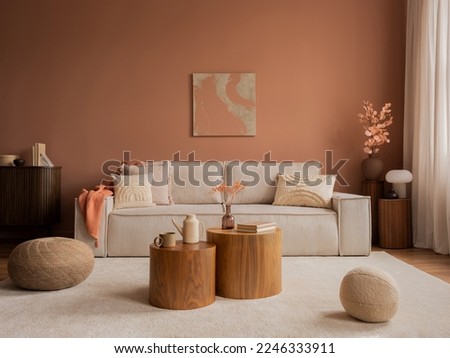 Warm and cozy living room interior with mock up poster frame, modular sofa, wooden coffee table, vase with dried flowers, pillows, armchair, pink wall and personal accessories. Home decor. Template. 