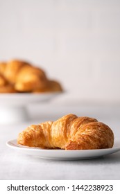 Warm Crispy Flaky Croissant Roll On White Plate And Distressed Table