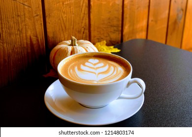 Warm Cup Of Dante's Inferno At A Local Coffee Shop With A Touch Of Fall In The Background