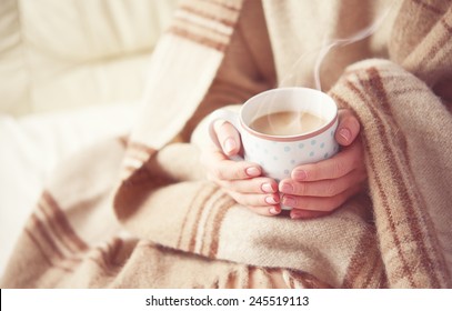warm cup of hot coffee warming in the hands of a girl - Powered by Shutterstock