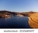 Warm dawn light view of Panormos bay on the north coast of the Greek island of Tinos in the Cyclades