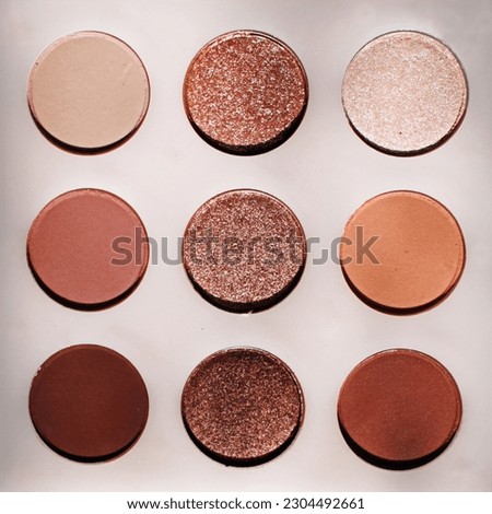 Warm eyeshadow color pallet with oranges and tan tones and glitter