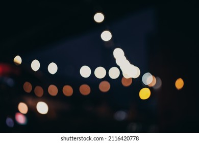 Warm Festive Bokeh Of String Lights Over An Outdoor Bar And Restaurant Patio At Twilight