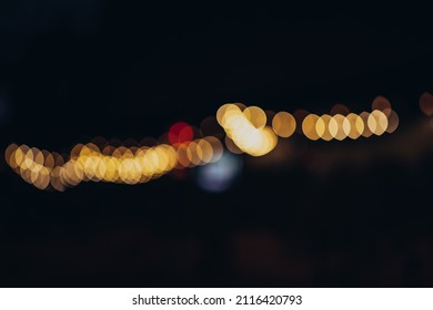 Warm Festive Bokeh Of String Lights Over An Outdoor Bar And Restaurant Patio At Twilight