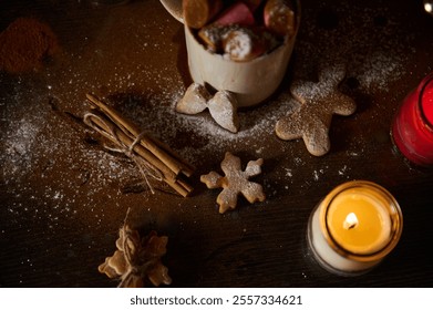 A warm and festive holiday scene with gingerbread cookies, cinnamon sticks, vibrant candles, and a sprinkled surface. - Powered by Shutterstock