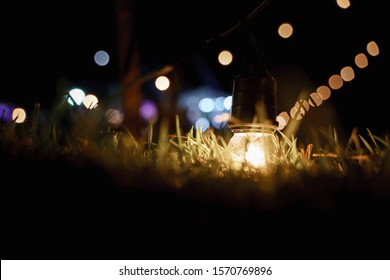 Warm Globe String Light Bulb On The Glass At Night Outdoor Event