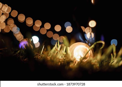 Warm Globe String Light Bulb On The Glass At Night Outdoor Event