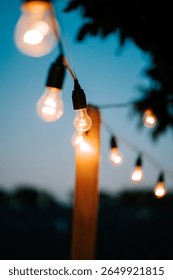 Warm glow of string lights illuminating a cozy outdoor space at dusk