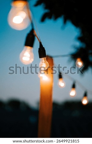 Warm glow of string lights illuminating a cozy outdoor space at dusk