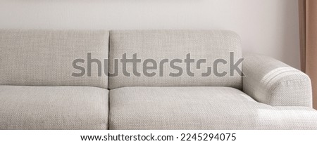 Warm grey sofa close up. Minimalistic furniture concept