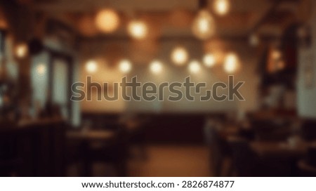 A warm and inviting cafe interior with soft, ambient lighting creating a cozy atmosphere. Comfortable seating arrangements are visible, suggesting a relaxed environment for patrons.
