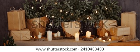 A warm and inviting Christmas setting featuring wrapped gifts, glowing candles, and a decorated tree. Concept: holiday home decor, festive blog posts, or greeting cards. Banner with copy space.