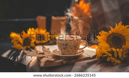 A warm, inviting image featuring a steaming cup of tea, sunflowers, and an open book, evoking a sense of comfort and the beauty of fall.