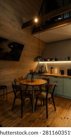 A warm and inviting rustic cabin kitchen and dining space featuring natural wood elements and soft ambient lighting