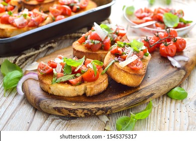 Warme italienische Bruschetta: Gebackenes italienisches Ciabatta-Brot mit Kirschtomaten, Basilikum und Parmesan-Käse, als Vorspeise