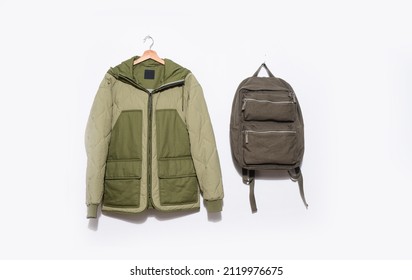 Warm jacket closeup  with backpack on hanger -white background.