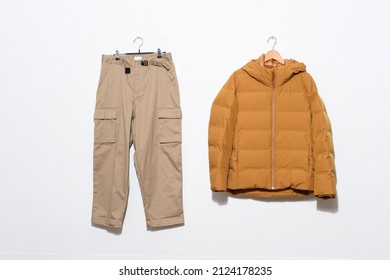 Warm Jacket With Khaki Pants On Hanging -white Background.

