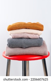 Warm Knitwear In A Pile On A Chair. Second Hand, Wardrobe Sorting, Cross-dressing, Economic Crisis, Money Saving, Waste Reduction.