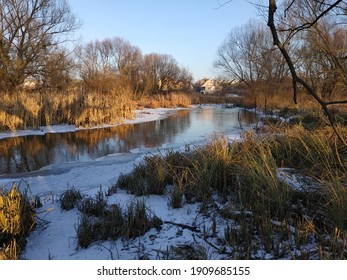 Warm landscape in the rays of the setting sun, the river, smoothly leaving into the distance
