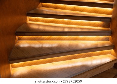Warm light glows under each step. Wooden stairs curve gently upward. Soft illumination enhances texture and depth. Modern design blends comfort with elegance. Ideal for luxury interiors, upscale homes