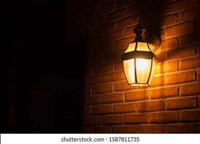 Warm Light Lantern Illuminating The Front Porch At Night