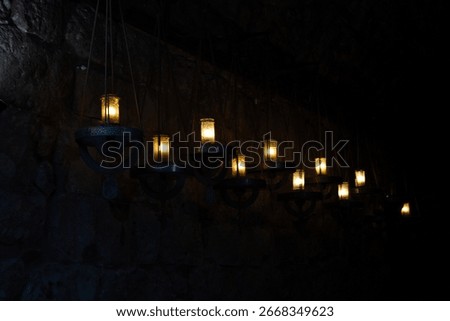 warm light lanterns on the ceiling with dark background.