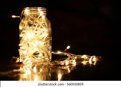 Warm light LED and a jar with dark background - Powered by Shutterstock