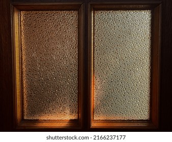 Warm Light Shines Through Textured Window