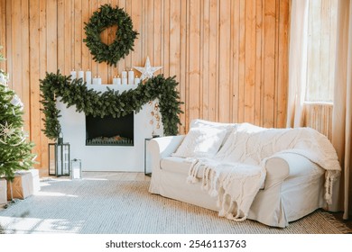 A warm living room adorned with a green wreath and garland, featuring a comfortable white couch, decorative lanterns, and a fireplace, all set against rustic wood paneling. - Powered by Shutterstock