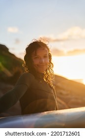 Warm Portrait Of Surfer Woman With SUP Board Posing On The Beach After Training