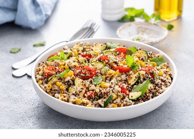 Warm quinoa salad with tomatoes, corn and zucchini with fresh mint and herbs - Powered by Shutterstock