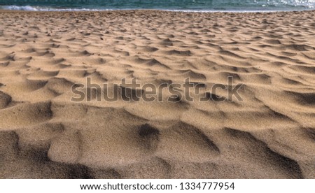 Warm sand under the bright sun in summer . Sand texture
