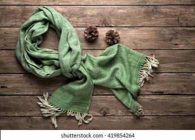  warm scarf on rustic with pine corn wooden background. Top view  - Powered by Shutterstock