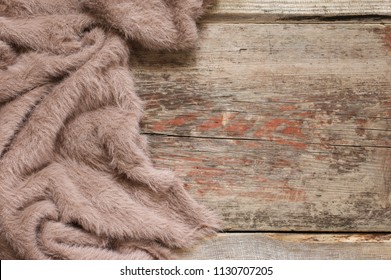 Warm Soft Blanket On Old Rustic Wood Background. Top View Point.