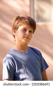 Warm Spring Day In A Green Park. Handsome Boy With Brown Hair And Green Eyes, Thoughtful