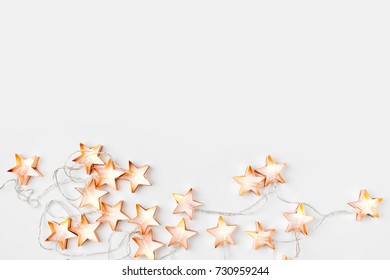 Warm star-shaped light garlands, festive decorations with copy space.  Christmas concept. Flat lay, top view - Powered by Shutterstock