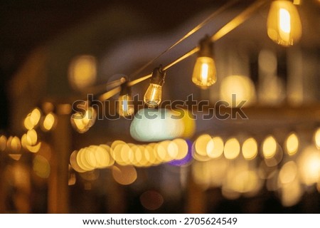 Warm string lights glowing softly in evening darkness