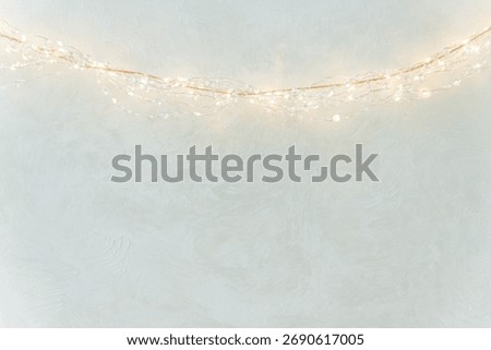 Warm String Lights on Textured Wall in Minimal Festive Interior