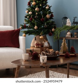 Warm and stylish christmas living room interior with design armchair, wooden coffee table, christmas tree, balls, gifts, red pillow, decoration and accessories. Santa claus is coming. Template. - Powered by Shutterstock