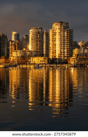 Warm Sunset Reflection False Creek Vancouver. Yaletown towers across False Creek at sunset in Vancouver. British Columbia, Canada.
