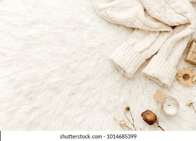 Warm sweater and dried flowers at white background. Cozy vintage. Flat lay, top view - Powered by Shutterstock