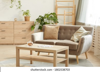 Warm Toned Background Image Of Cozy Home Interior Featuring Comfortable Beige Sofa And Coffee Table, Copy Space