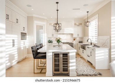 Warm White Kitchen With Expansive Countertops Island High End Appliances Spice Kitchen Black Leather Chair Dining Table Wine Fridge And Office Work Station