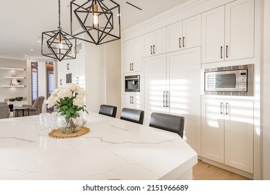 Warm White Kitchen With Expansive Countertops Island High End Appliances Spice Kitchen Black Leather Chair Dining Table Wine Fridge And Office Work Station