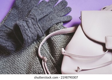 Warm Winter Outfit Flat Lay Photography. Gray Woolen Gloves, Knitted Scarf And Backpack. Women's Clothes And Accessories For Cold Weather