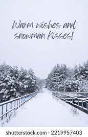 Warm Wishes And Snowman Kisses Inspiration Joke Quote Phrase Winter Holiday Landscape Forest Dramatic View Of Snow-capped Spruces On Frosty Day. New Year And Christmas Greeting Card Vertical