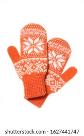 Warm woolen knitted mittens isolated on white background. Orange knitted mittens with pattern.