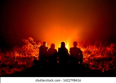 warming up in front of the campfire - Powered by Shutterstock